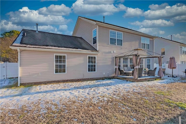 back of property featuring outdoor lounge area, a gazebo, and a deck