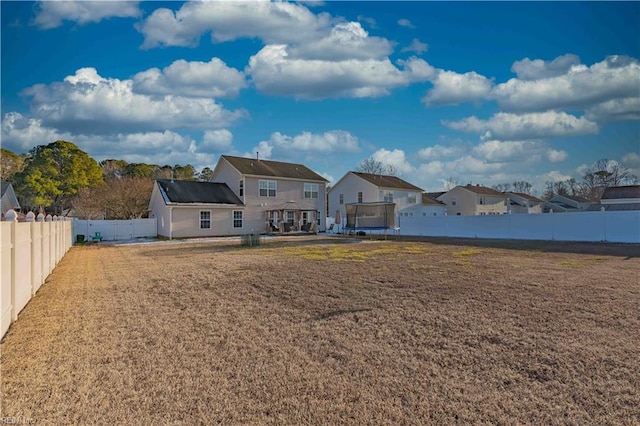 back of house featuring a trampoline