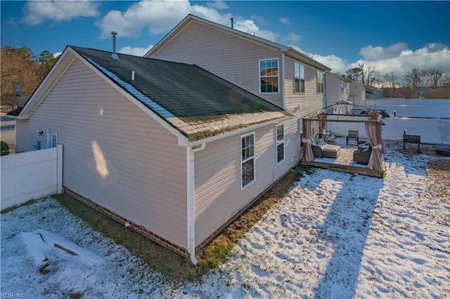 view of snowy exterior featuring a gazebo and a wooden deck