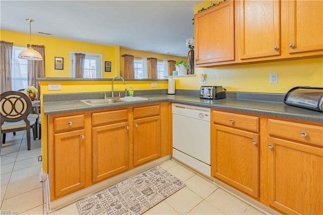 kitchen with dishwasher, sink, plenty of natural light, light tile patterned flooring, and kitchen peninsula