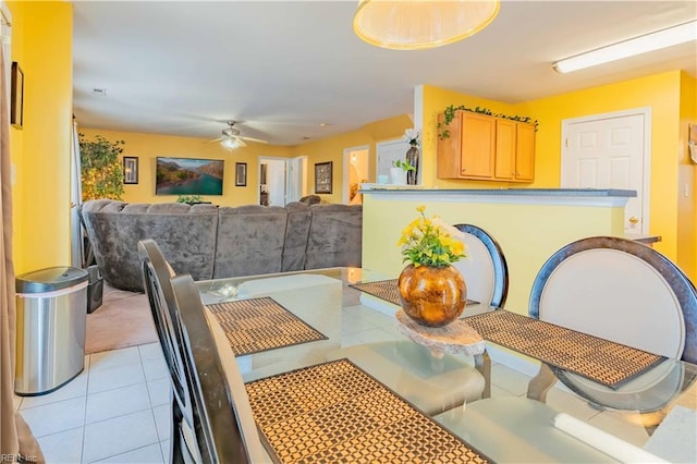 tiled dining room featuring ceiling fan