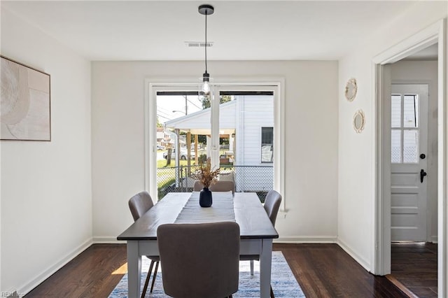 dining room featuring a notable chandelier and dark hardwood / wood-style floors