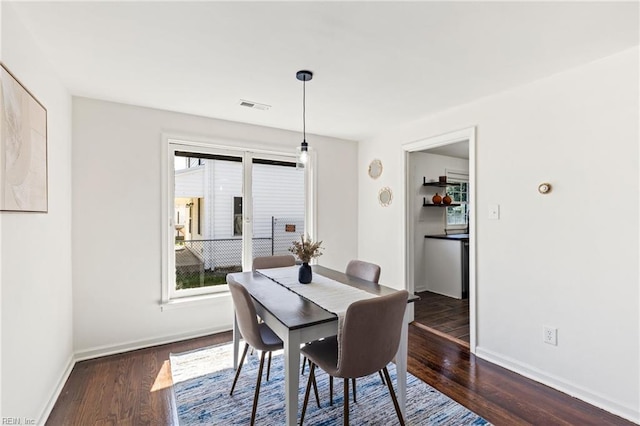 dining space featuring dark wood-type flooring