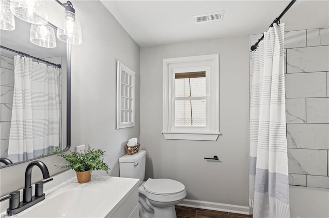 full bathroom with shower / bath combo, vanity, and toilet