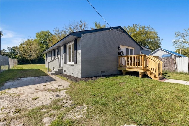 view of property exterior with a yard and a wooden deck