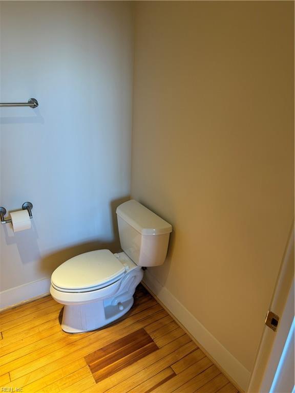 bathroom with toilet and wood-type flooring