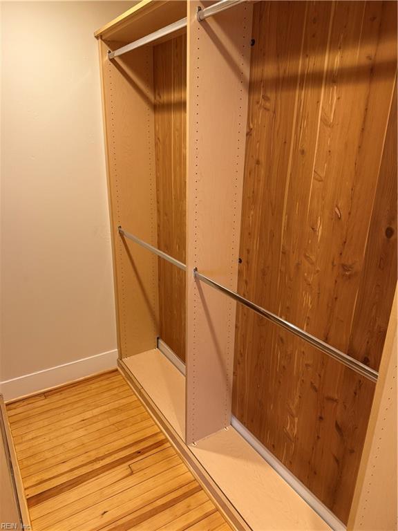 spacious closet featuring hardwood / wood-style flooring