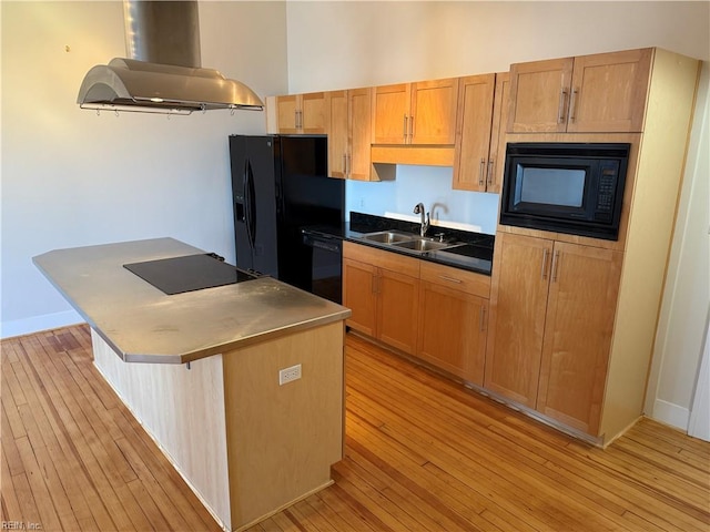 kitchen with island range hood, sink, black appliances, a center island, and light hardwood / wood-style floors