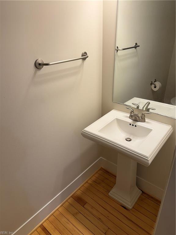 bathroom with hardwood / wood-style floors