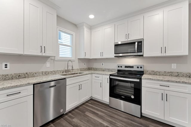 kitchen featuring sink, white cabinets, dark wood-type flooring, and appliances with stainless steel finishes