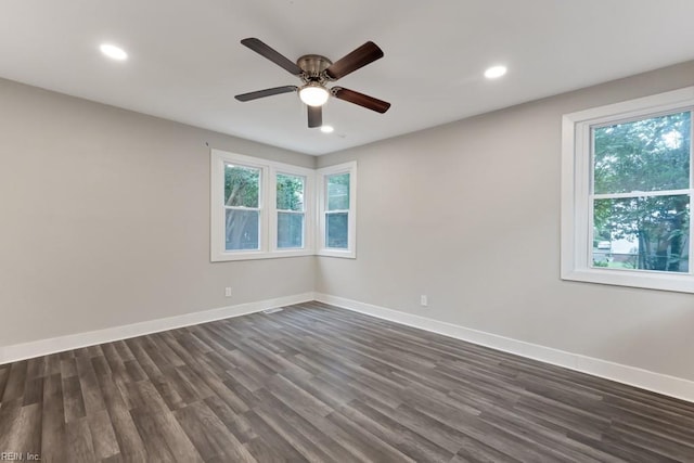 spare room with ceiling fan and dark wood-type flooring