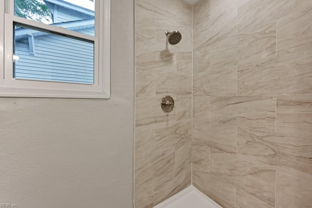 bathroom featuring tiled shower