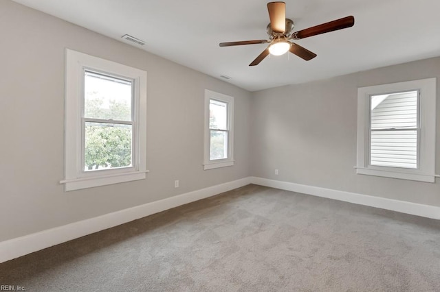 carpeted empty room featuring ceiling fan