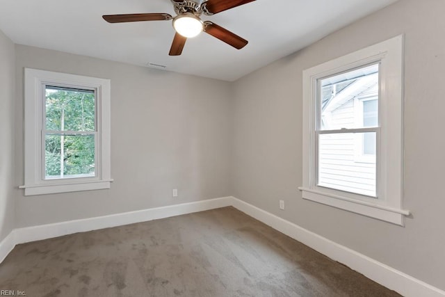 empty room featuring ceiling fan and carpet floors