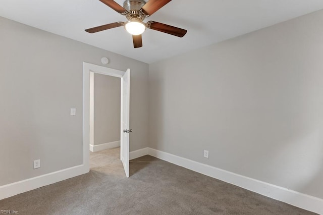 spare room featuring light colored carpet and ceiling fan