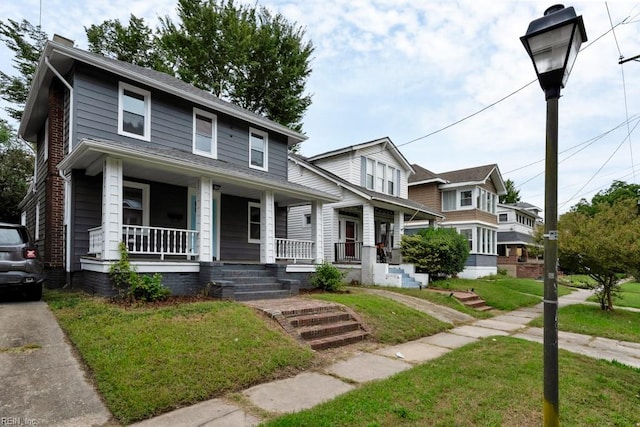 view of front facade with covered porch and a front yard