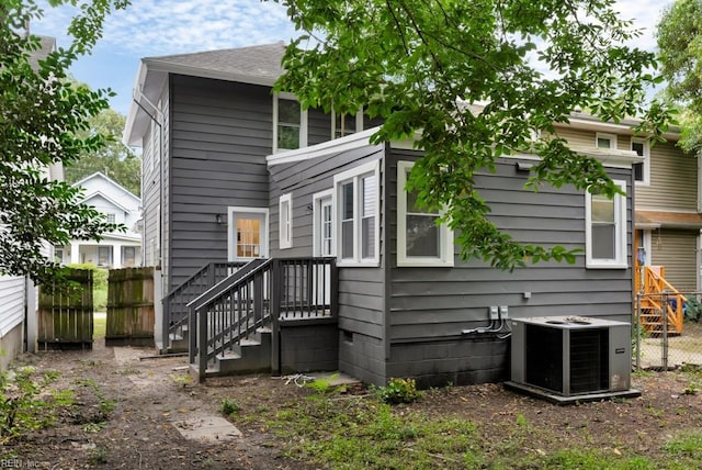 rear view of property with cooling unit