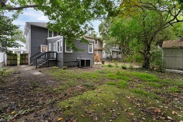 rear view of property featuring cooling unit