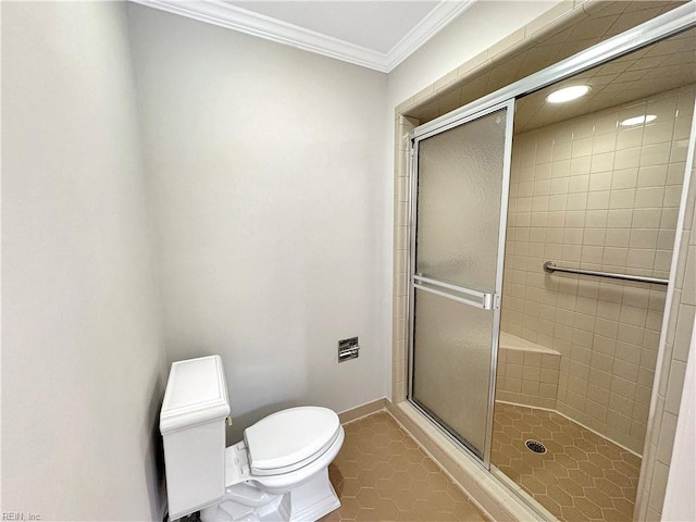 bathroom with tile patterned flooring, toilet, ornamental molding, and an enclosed shower