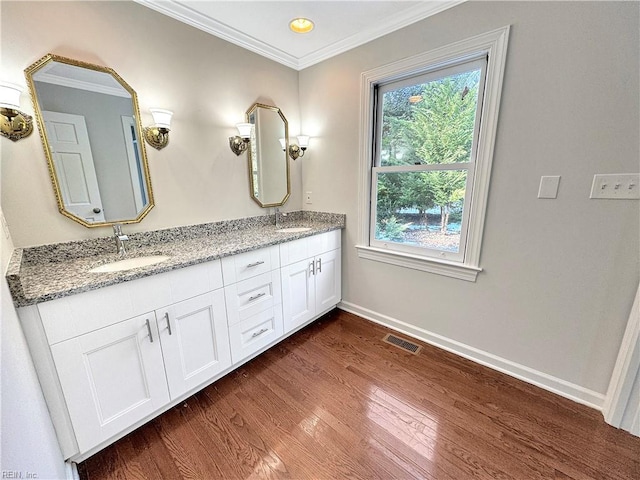 bathroom with hardwood / wood-style flooring, vanity, and crown molding