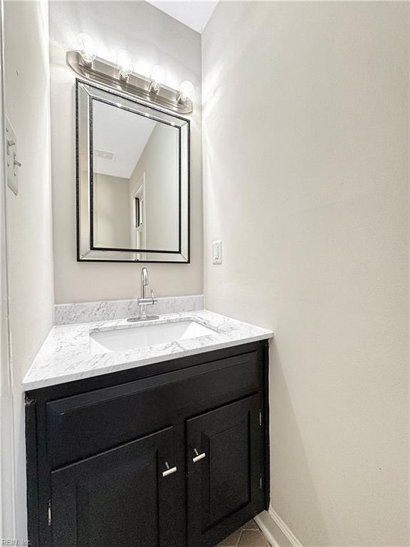 bathroom with tile patterned floors and vanity