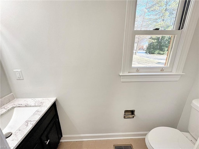 bathroom with tile patterned floors, vanity, and toilet