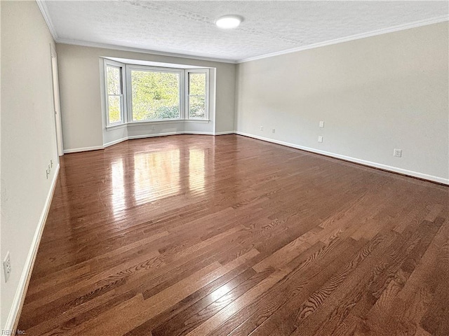 unfurnished room with dark hardwood / wood-style floors, ornamental molding, and a textured ceiling