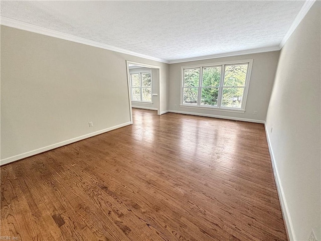 empty room featuring hardwood / wood-style floors, crown molding, and a textured ceiling