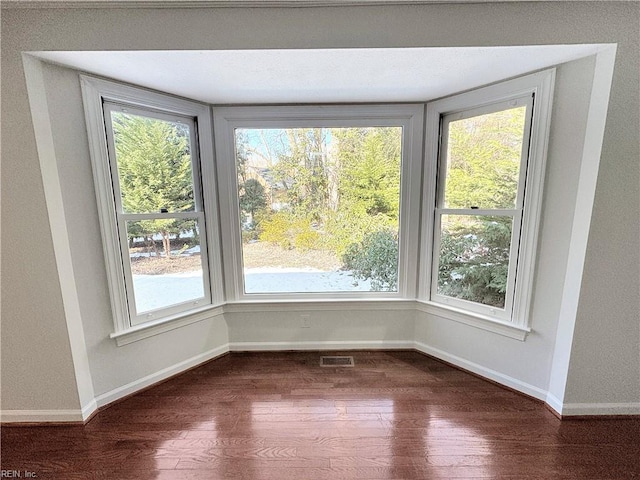 unfurnished dining area with dark hardwood / wood-style floors