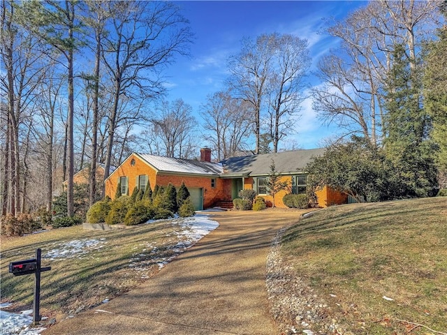 ranch-style home with a garage and a front yard