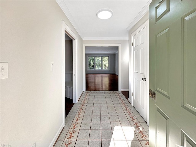 hall with ornamental molding and light tile patterned floors