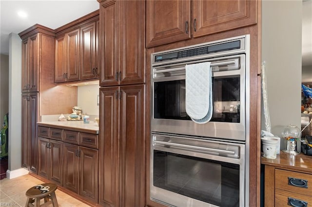 kitchen featuring light tile patterned floors and double oven