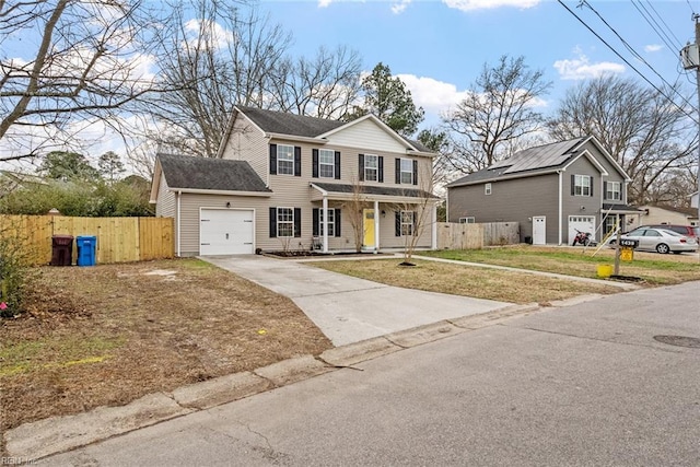 view of front of property featuring a front yard, a garage, and covered porch