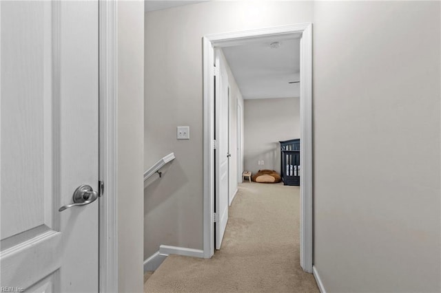 hallway featuring light carpet