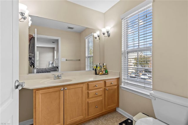 bathroom featuring vanity and toilet