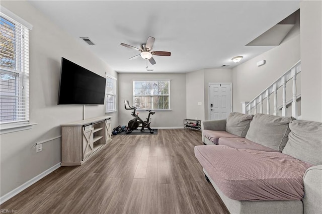 living room with hardwood / wood-style floors and ceiling fan