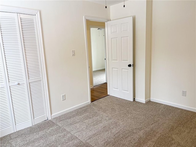 unfurnished bedroom featuring a closet and carpet floors