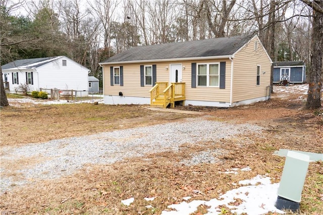 view of front of house with a storage shed