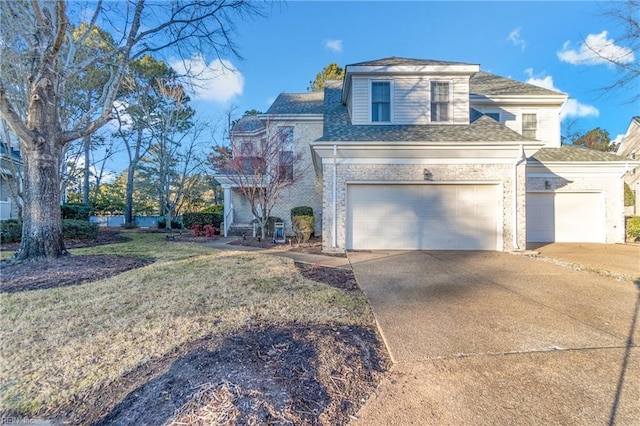 view of property with a garage and a front lawn