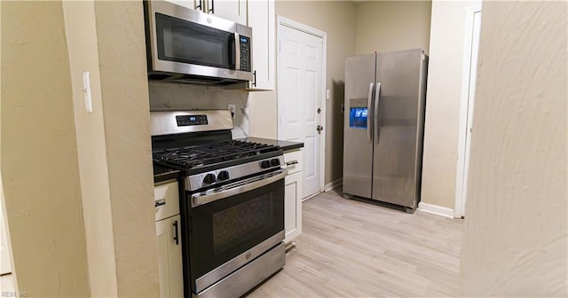 kitchen featuring white cabinets, stainless steel appliances, and light hardwood / wood-style floors