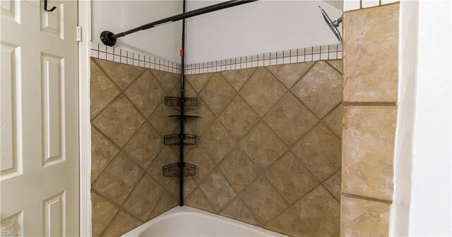 interior details featuring tiled shower / bath