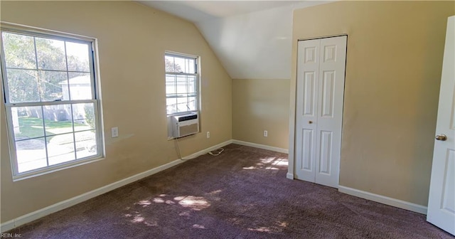 bonus room featuring cooling unit, dark carpet, and vaulted ceiling