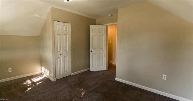 bonus room featuring lofted ceiling and dark colored carpet