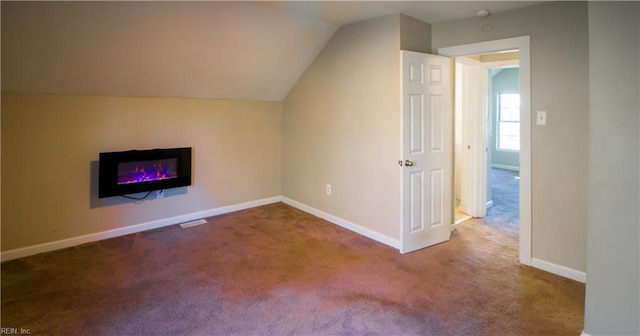 additional living space with carpet and vaulted ceiling