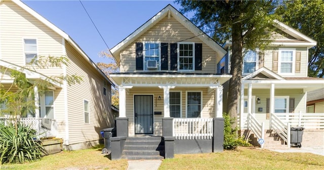 view of front of home with covered porch and a front yard