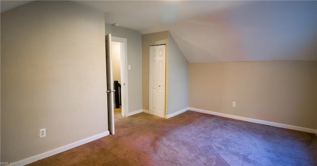 additional living space with carpet flooring and vaulted ceiling