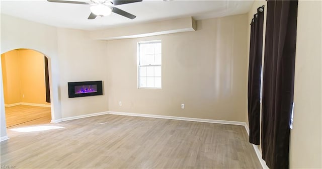 spare room with light wood-type flooring and ceiling fan