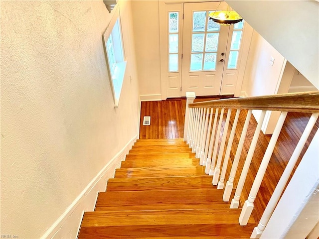 stairs with hardwood / wood-style floors