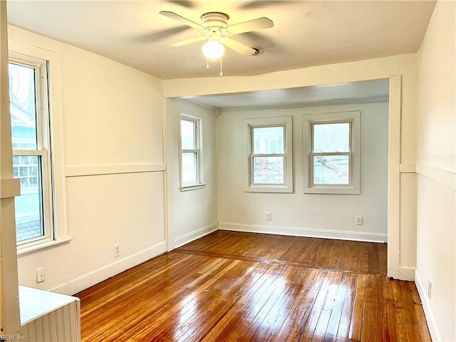 unfurnished room with ceiling fan and hardwood / wood-style flooring