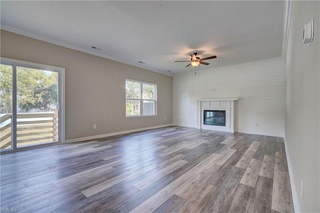 unfurnished living room with hardwood / wood-style floors, ceiling fan, and ornamental molding